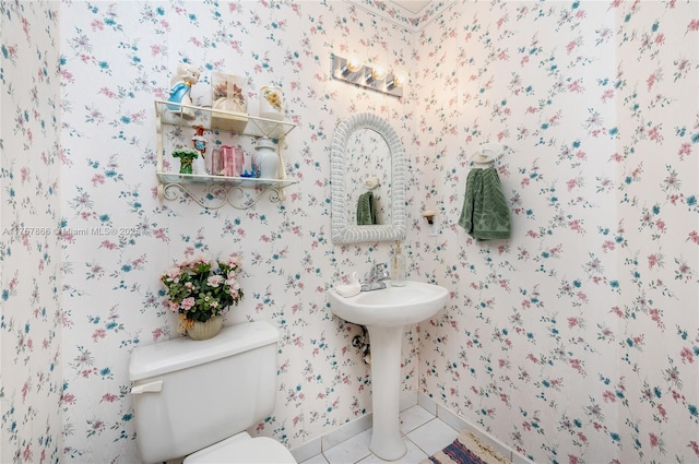 half bathroom featuring toilet, wallpapered walls, and tile patterned floors