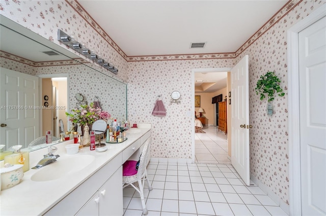 bathroom with double vanity, wallpapered walls, a sink, and tile patterned floors