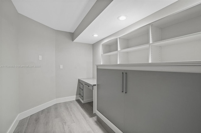 washroom with recessed lighting, light wood-type flooring, and baseboards