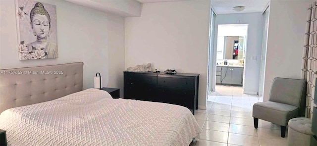 bedroom featuring light tile patterned flooring and connected bathroom