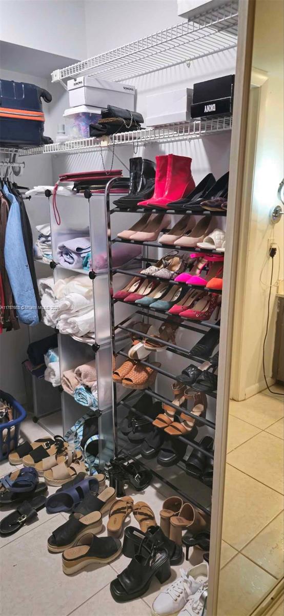 spacious closet featuring tile patterned flooring