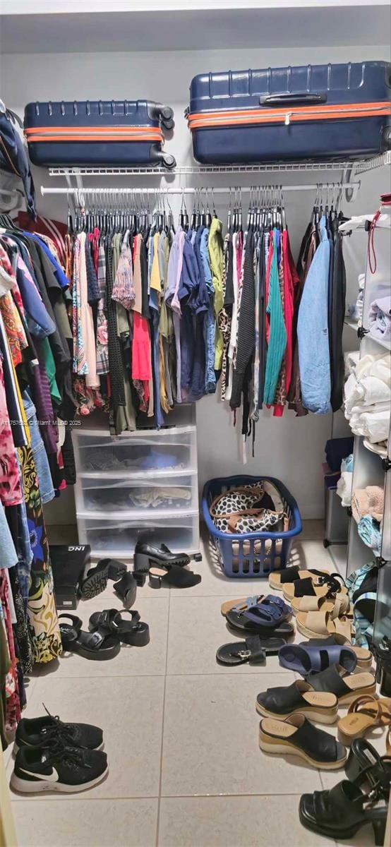 spacious closet with tile patterned floors