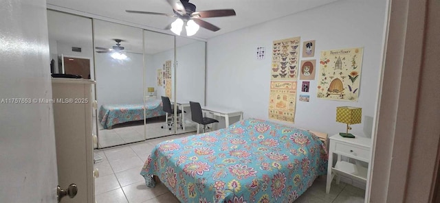 bedroom featuring light tile patterned floors, a closet, and ceiling fan