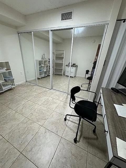 home office with tile patterned floors and visible vents