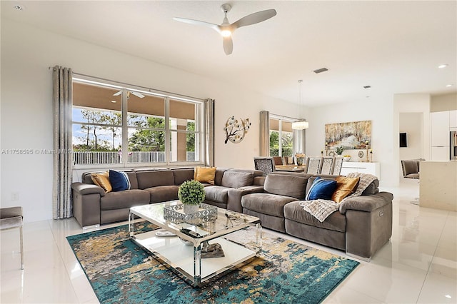 living room featuring visible vents, ceiling fan, and light tile patterned floors