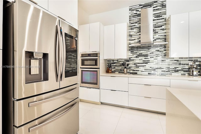 kitchen with stainless steel appliances, white cabinets, backsplash, and modern cabinets