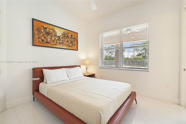 bedroom with vaulted ceiling and baseboards