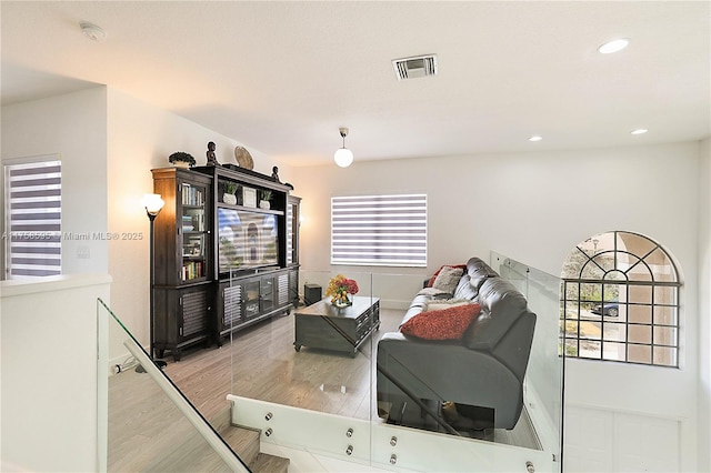 living room featuring recessed lighting, visible vents, and wood finished floors