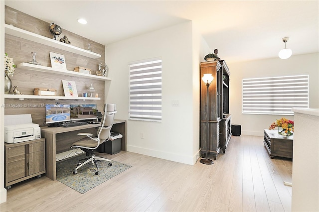 home office featuring baseboards and wood finished floors