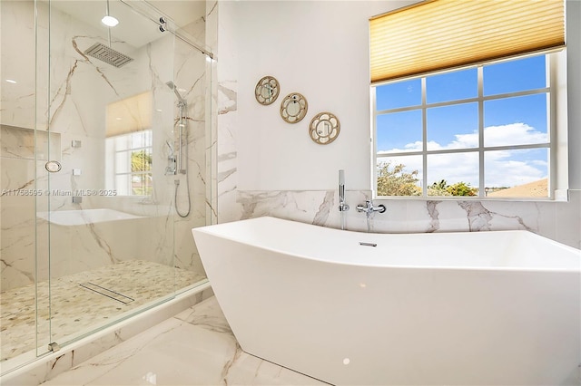 full bathroom featuring marble finish floor, a marble finish shower, and a wealth of natural light