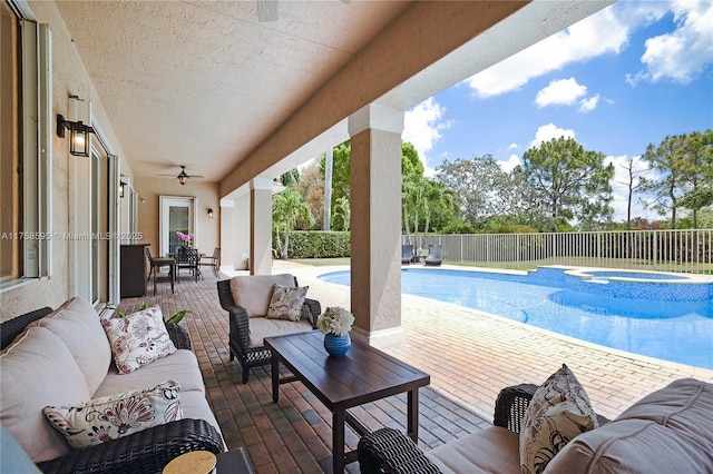 view of pool featuring an in ground hot tub, outdoor lounge area, fence, a fenced in pool, and a patio area