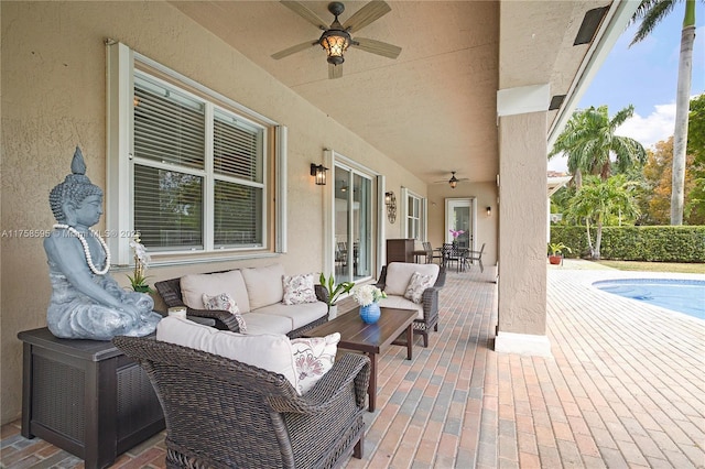 view of patio / terrace with a ceiling fan, outdoor dining space, a fenced in pool, and an outdoor hangout area