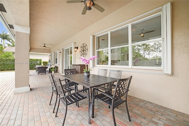 view of patio featuring outdoor dining area and ceiling fan