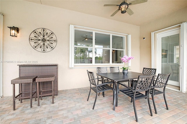 view of patio with outdoor dining space and ceiling fan