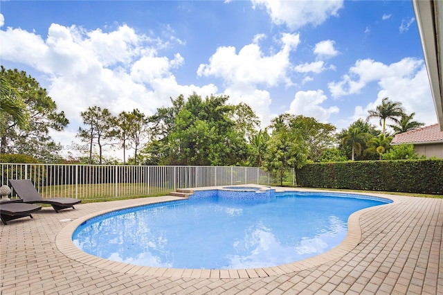 view of swimming pool with a pool with connected hot tub, a patio area, and fence