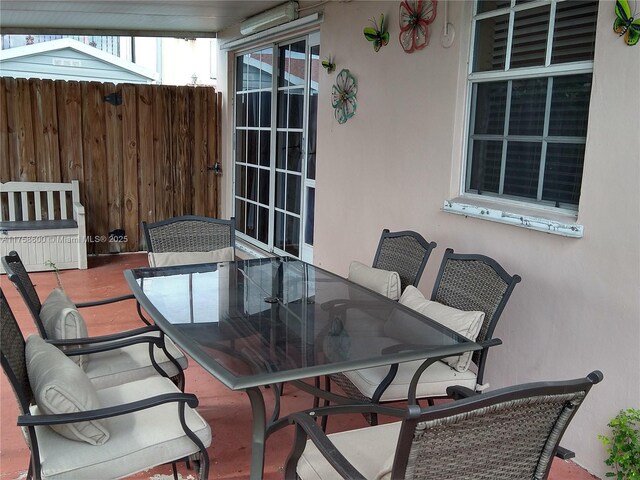 view of patio / terrace featuring fence and outdoor dining space