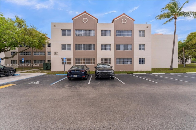 view of building exterior with uncovered parking