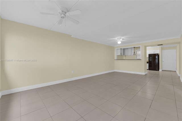 empty room featuring crown molding, baseboards, a ceiling fan, and light tile patterned flooring