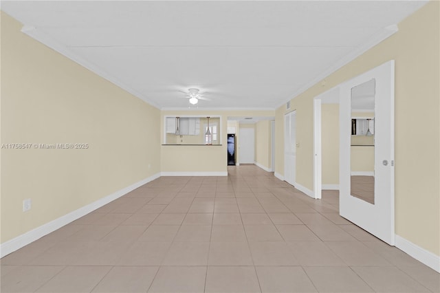 unfurnished room with light tile patterned floors, ceiling fan, ornamental molding, and baseboards