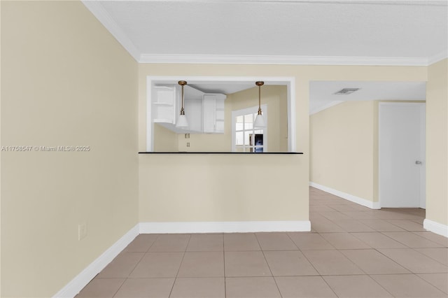 kitchen with visible vents, baseboards, ornamental molding, tile patterned floors, and dark countertops