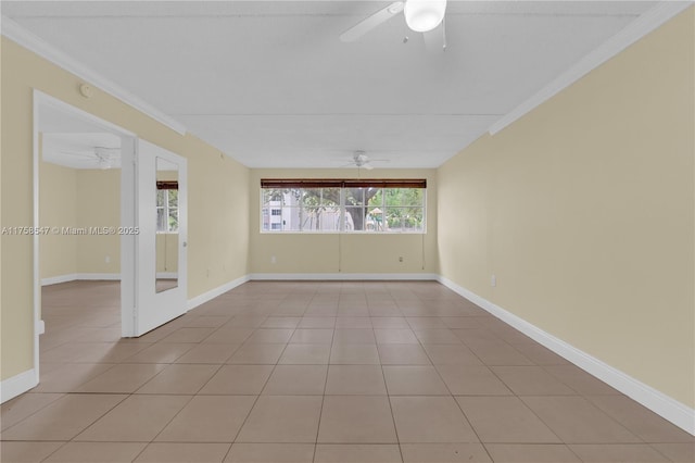 empty room with baseboards, a ceiling fan, crown molding, and light tile patterned flooring