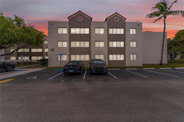 view of building exterior featuring uncovered parking