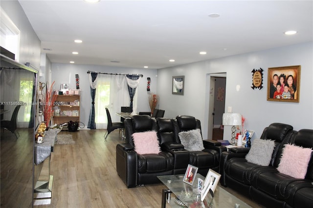 living area with light wood finished floors and recessed lighting