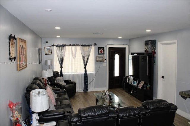 living room with baseboards, wood finished floors, and recessed lighting