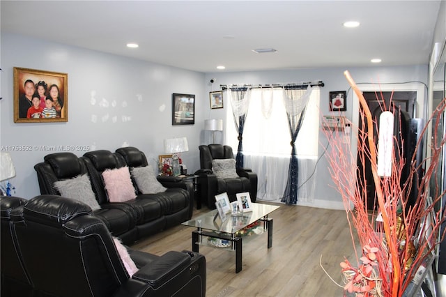 living area featuring baseboards, recessed lighting, and light wood-style floors