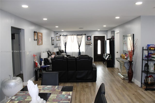living room with light wood-style floors, recessed lighting, and baseboards