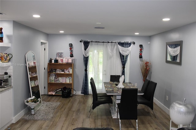 dining room featuring recessed lighting, visible vents, baseboards, and wood finished floors