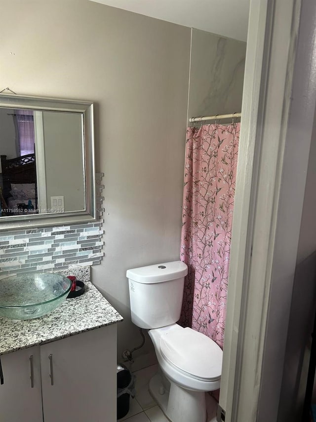 full bath with toilet, a shower with curtain, backsplash, and vanity
