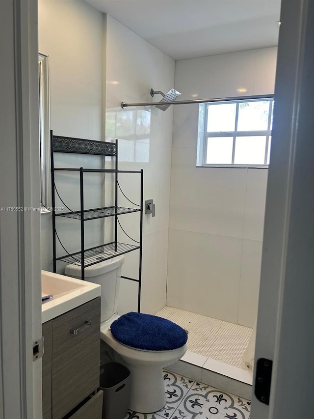 bathroom with a stall shower, tile patterned flooring, vanity, and toilet