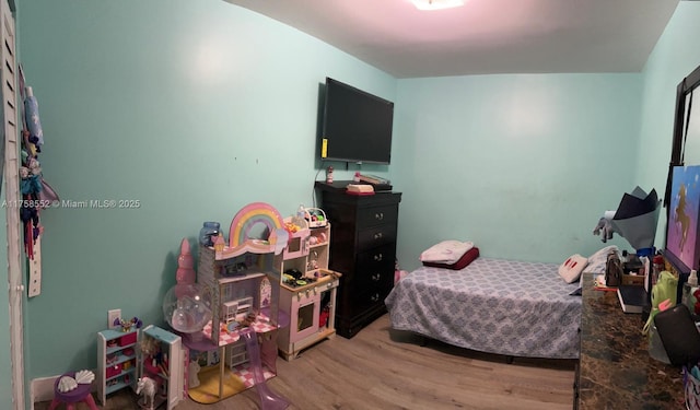 bedroom with light wood-style floors