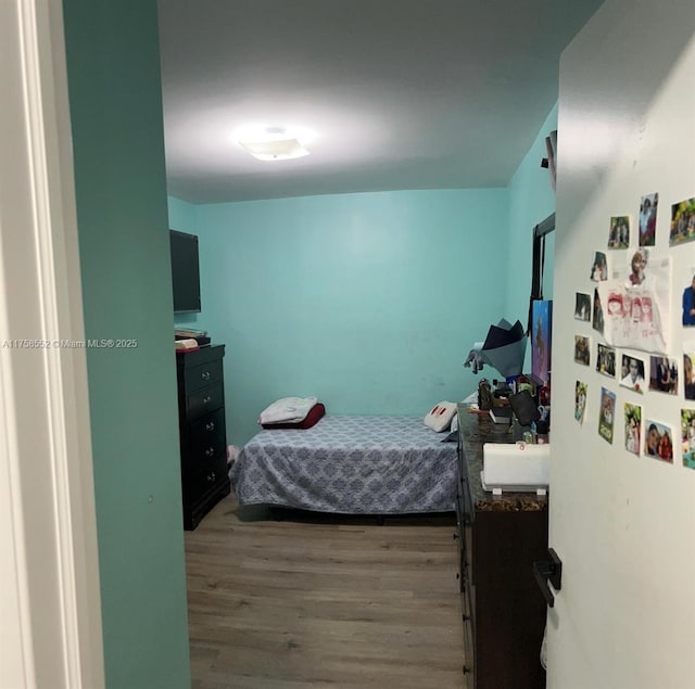 bedroom with wood finished floors