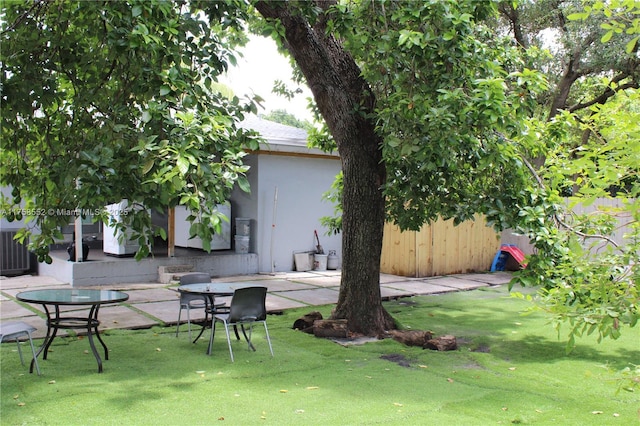 view of yard featuring a patio area and central AC
