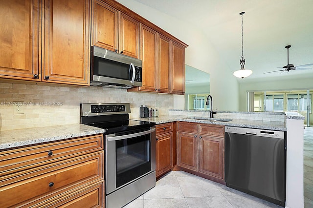 kitchen featuring stainless steel appliances, brown cabinets, and a sink