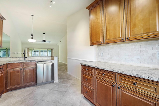 kitchen with light stone counters, decorative backsplash, stainless steel dishwasher, brown cabinetry, and a sink