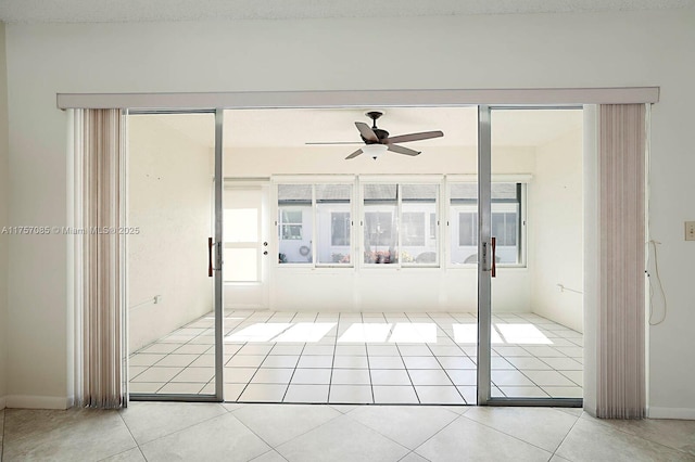 spare room with a ceiling fan and tile patterned flooring