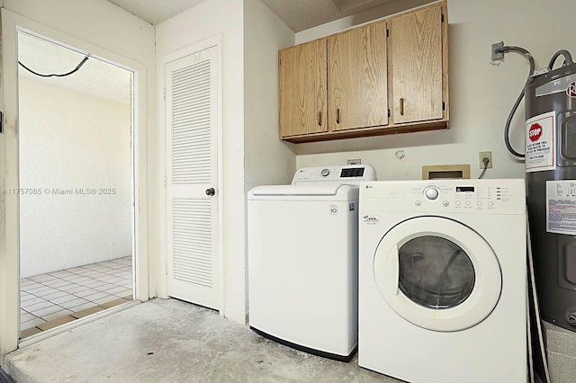 clothes washing area featuring cabinet space, washer and clothes dryer, and electric water heater