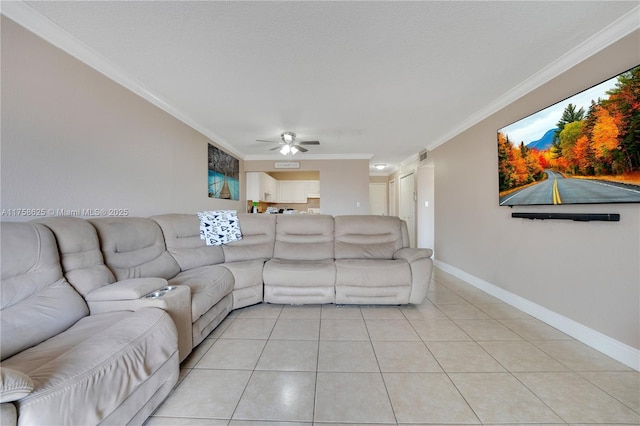 living room with baseboards, visible vents, a ceiling fan, ornamental molding, and light tile patterned flooring