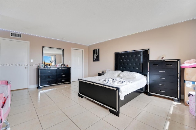 bedroom with light tile patterned flooring and visible vents