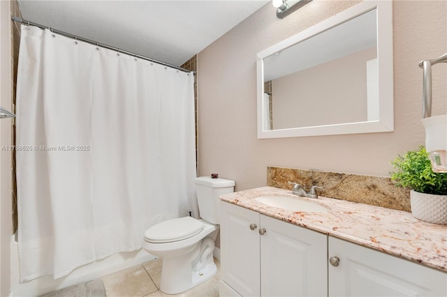 bathroom with shower / bath combo, vanity, toilet, and tile patterned floors