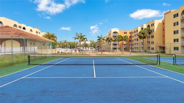 view of tennis court with fence