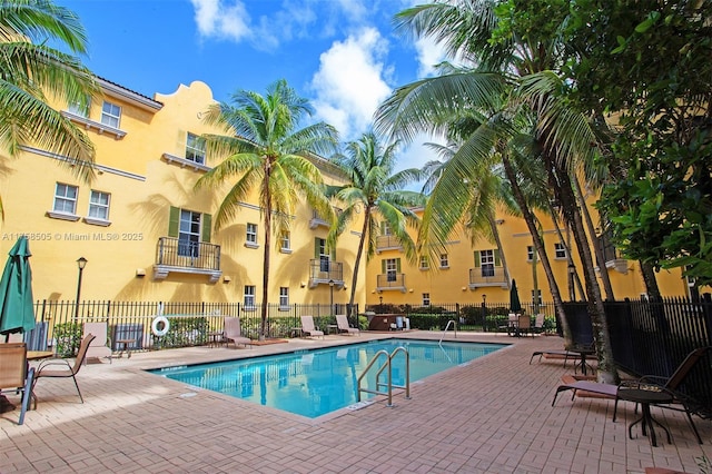 pool featuring fence and a patio