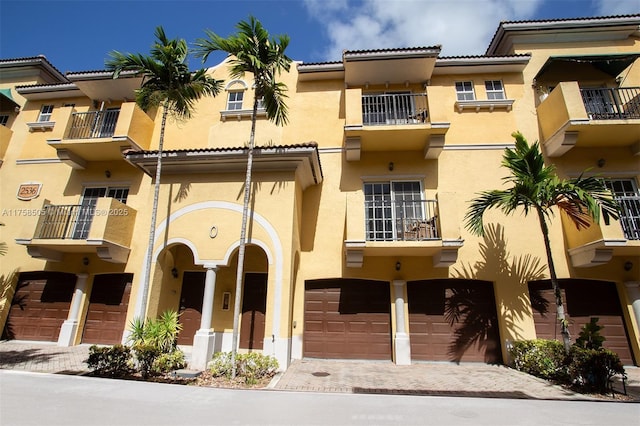 view of property featuring a garage and driveway