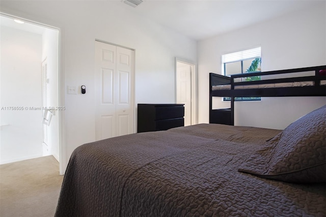 carpeted bedroom with a closet and visible vents