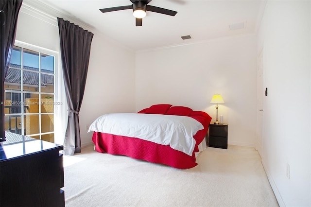 carpeted bedroom with a ceiling fan, visible vents, crown molding, and baseboards