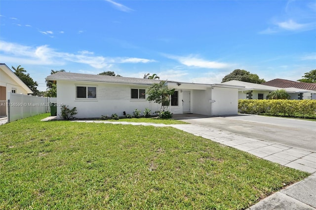 814 NE 4th St, Hallandale Beach, FL 33009 - ranch-style home with a front lawn, fence, stucco siding, and concrete driveway
