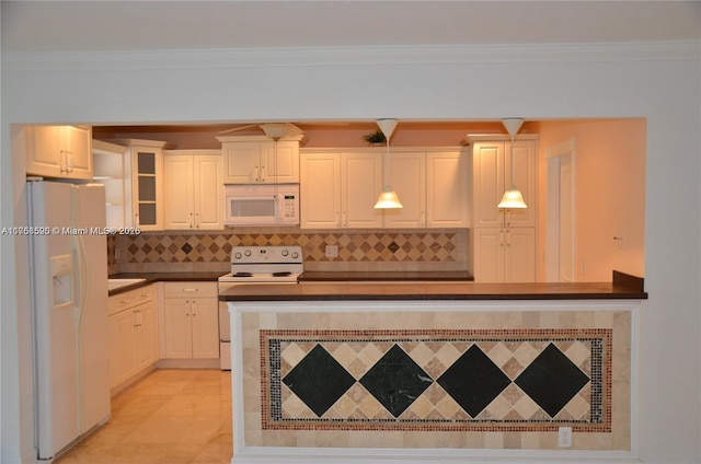 kitchen with white appliances, dark countertops, backsplash, and crown molding